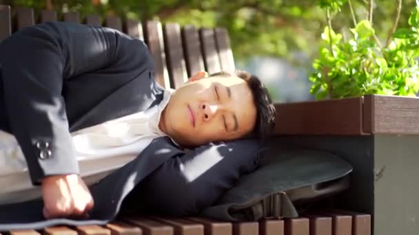 Exhausted Overworked Young Asian Businessman Lying Bench City Central Park — Stock Video