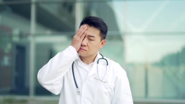 Portrait Stressful Asian Doctor Sitting Standing Hospital Outdoors Tired Pensive — Stock Video