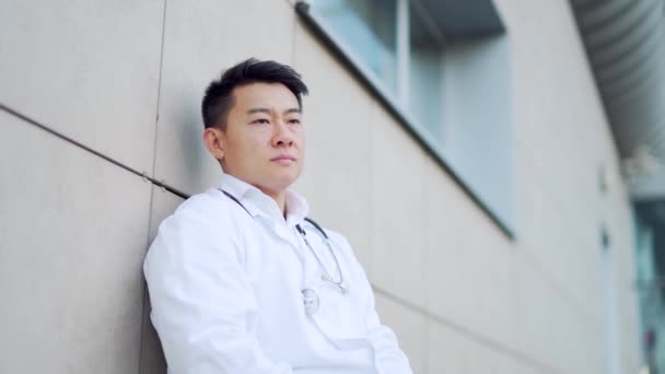 Portrait Stressful Asian Doctor Sitting Standing Hospital Outdoors Tired Pensive — Stock Video