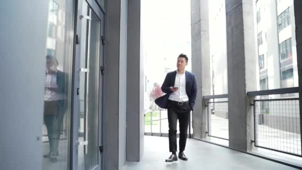 Male Asian Businessman Unlocking Door Using Mobile Phone Application Unlocks — Stock Video