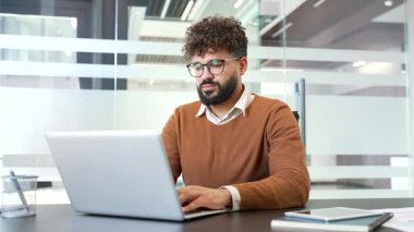 İş yerindeki çalışma masasında otururken sırt ağrısı çeken sağlıksız bir işadamı. Yorgun, çok çalışan, sıradan süveter giyen bir adam rahatsız, masajlar acı verici, bel altı kasları.