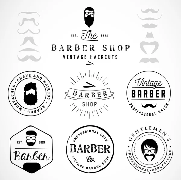 Vintage barbería insignias y etiquetas — Vector de stock