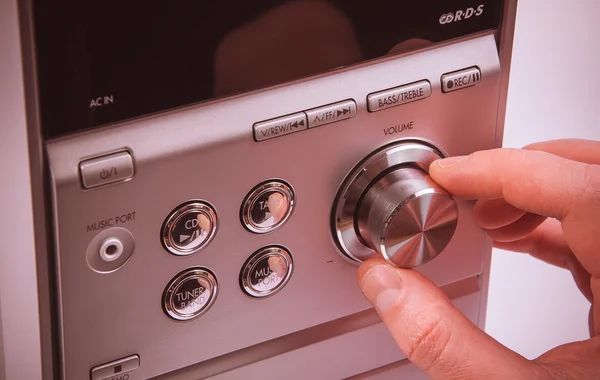 Hand on Sound volume control knob — Stock Photo, Image