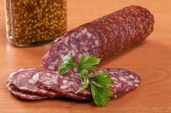 Salami for Breakfast with pepper on a wooden table — Stock Photo, Image