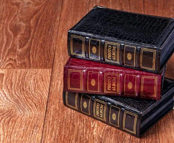 Vintage old books on wooden deck tabletop against grunge wall — Stock Photo, Image