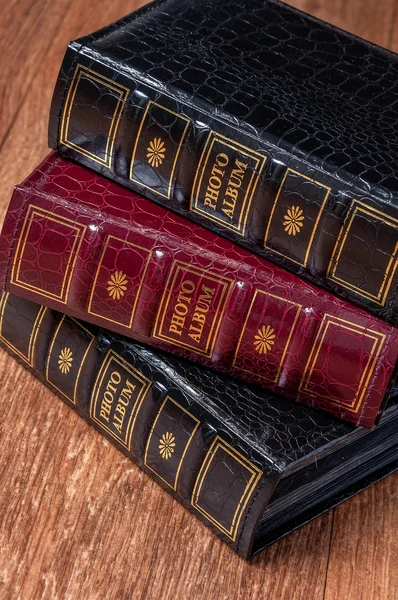 Vintage old books on wooden deck tabletop against grunge wall — Stock Photo, Image