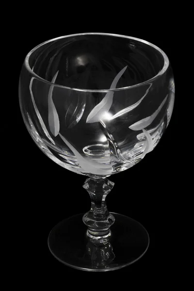 Empty crystal cognac glass on a black background — Stock Photo, Image