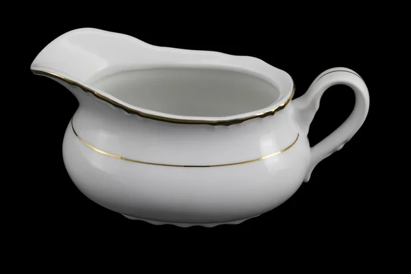 Porcelain sauce-boat on a black background — Stock Photo, Image