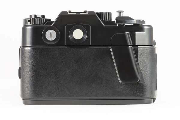 Back side of film single-lens reflex camera (SLR) on white