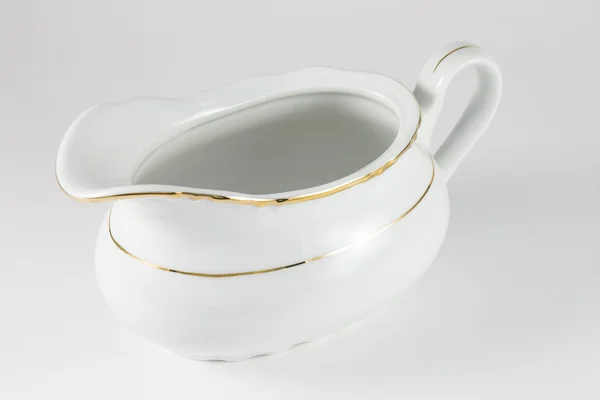 Porcelain gravy boat with a gold border — Stock Photo, Image