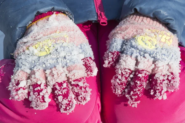 Lumps of frozen snow on woolen gloves — Stock Photo, Image