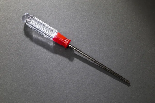 Metal Phillips screwdriver with a transparent plastic handle — Stock Photo, Image