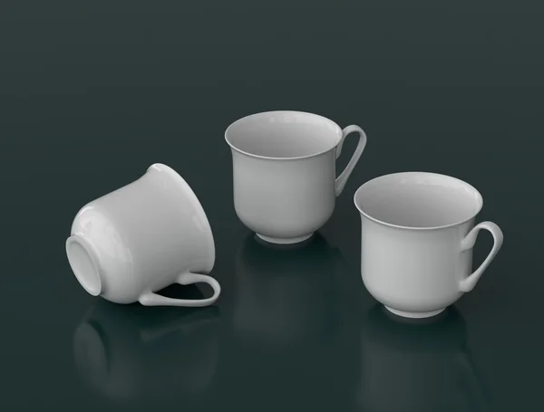 Üç beyaz porselen çay bardaklarından karanlık bir arka plan üzerinde — Stok fotoğraf