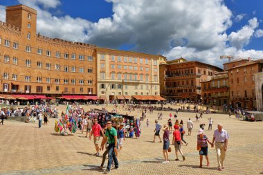 Siena, Italy. Tourists walk on Piazza del Campo
