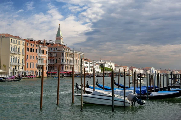 Venice, Italy. Parked motor boat and gondolas in a row — Stock Photo, Image