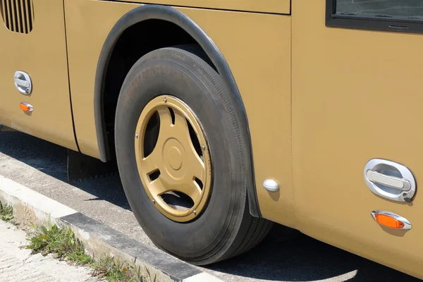 Wheel of the yellow bus near the curb — Stock Photo, Image