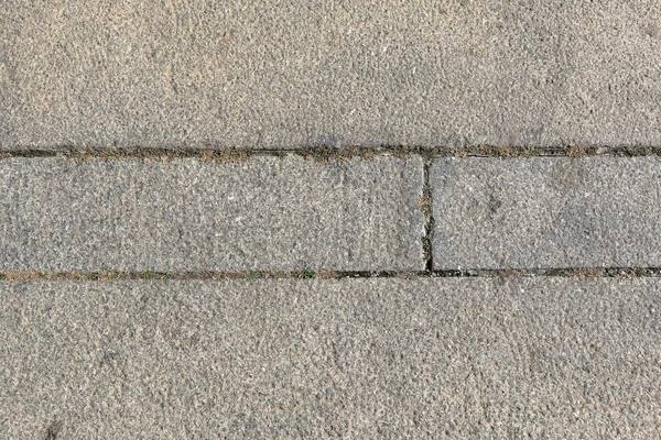 Rough granite blocks with grass — Stock Photo, Image