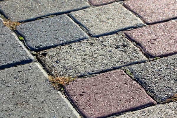 Pavement from multicolor cobblestone close-up