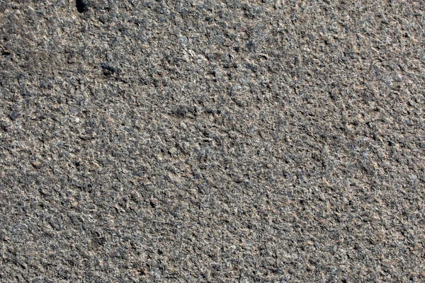 Textura de uma antiga superfície de granito áspero close-up. Contexto — Fotografia de Stock