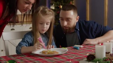 Anne ve babası küçük kızının çalışmalarını gözlemlemek için geldiler.