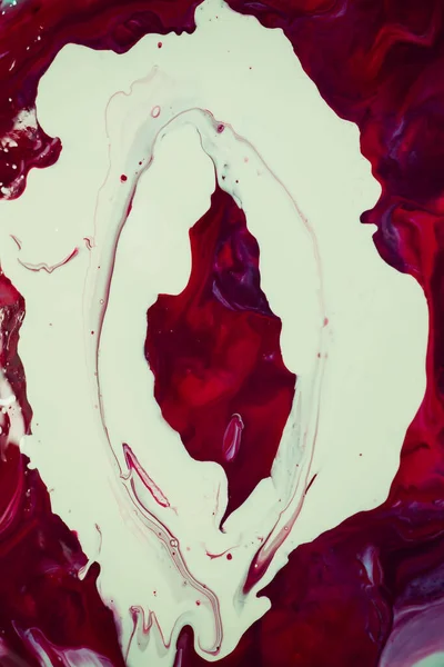 Art fluid. The female vagina is painted with fluid. The art of seeing is beautiful. Red and white fluid.