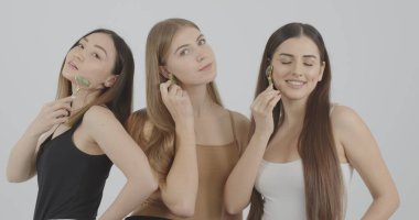 girls enjoy the process of massaging the skin with new beauty devices