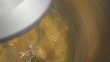 Elektrikli mikserle yumurta çırpma sahnesi. Yemek pişirmek için mutfak aygıtı.