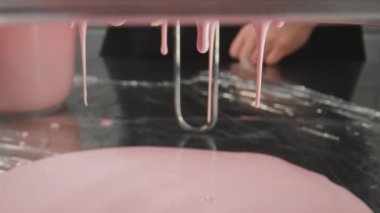 The cream drips on the table. Confectionery process of making cream for a cake.