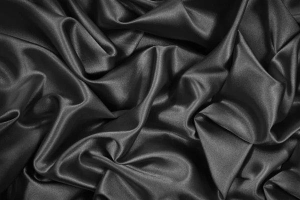 黒い絹のサテン 黒い光沢のある生地の背景 美しい明るい抽象的背景 — ストック写真