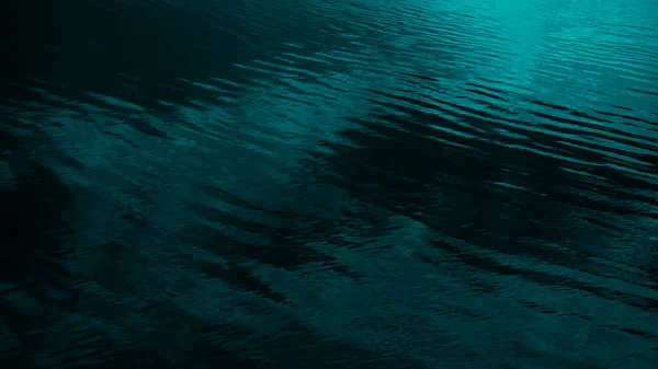 Dark blue green abstract background. Reflection of light on a smooth surface of water with small waves. Seascape. Marine. Tidewater green background with copy space for design. Web banner.