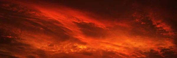 Blood red sky with clouds. Fiery sunset background with copy space for design. Web banner. Website header. Armageddln, catastrophe, apocalypse, burst, explosion, fantasy, war, horror concept.