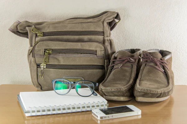 Still life with casual man, boots and bag on wooden table over g — Stock Photo, Image