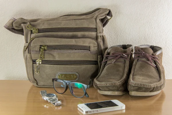 Still life with casual man, boots and bag on wooden table over g — Stock Photo, Image