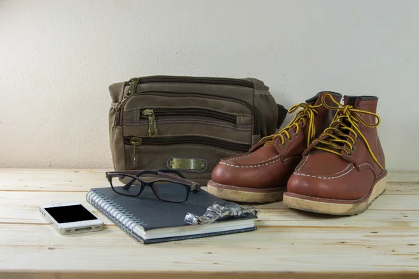 Still life with casual man, boots and bag on wooden table backgr — Stock Photo, Image