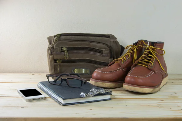 Still life with casual man, boots and bag on wooden table backgr — Stock Photo, Image