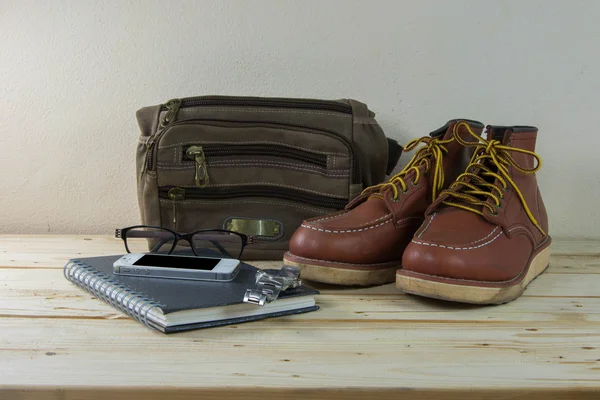 Still life with casual man, boots and bag on wooden table backgr — Stock Photo, Image