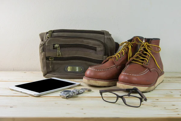 Still life with casual man, boots and bag on wooden table backgr — Stock Photo, Image