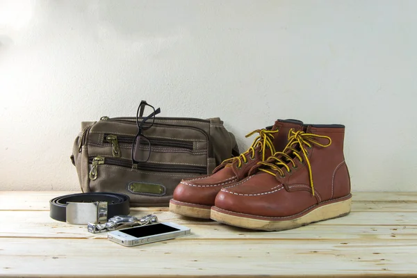 Still life with casual man, boots and bag on wooden table backgr — Stock Photo, Image