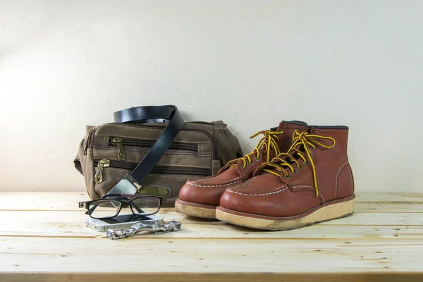 Still life with casual man, boots and bag on wooden table backgr — Stock Photo, Image