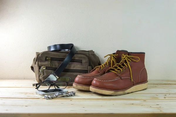 Still life with casual man, boots and bag on wooden table backgr — Stock Photo, Image