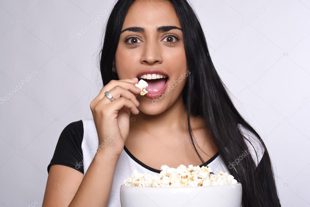 Young woman eating popcorn — Stock Photo © 105625500