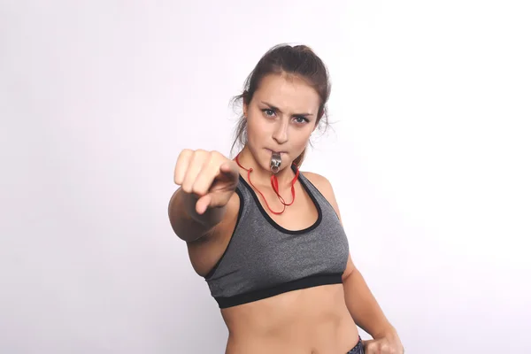 Portrait of an athlete young woman with whistle. Stock Image