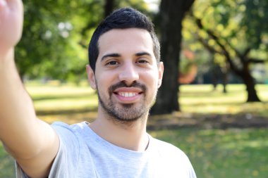 Bir selfie bir parkta alarak genç latin adam. 