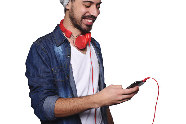 Young latin man with headphones and smartphone.