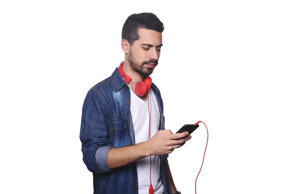 Jeune homme latino avec écouteurs et smartphone . — Photo