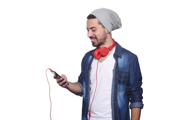 Young latin man with headphones and smartphone. — Stock Photo, Image