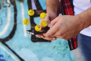 Man using phone sending emojis clipart