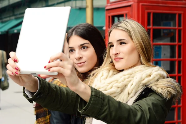 Δύο νέοι φίλες λαμβάνοντας αυτοπορτρέτα με tablet. — Φωτογραφία Αρχείου