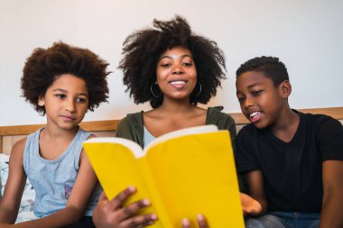 Afro anne çocuklarına kitap okuyor..