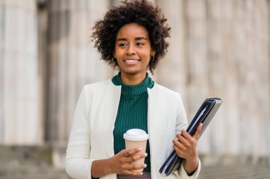 Afro iş kadını sokakta yürüyor..